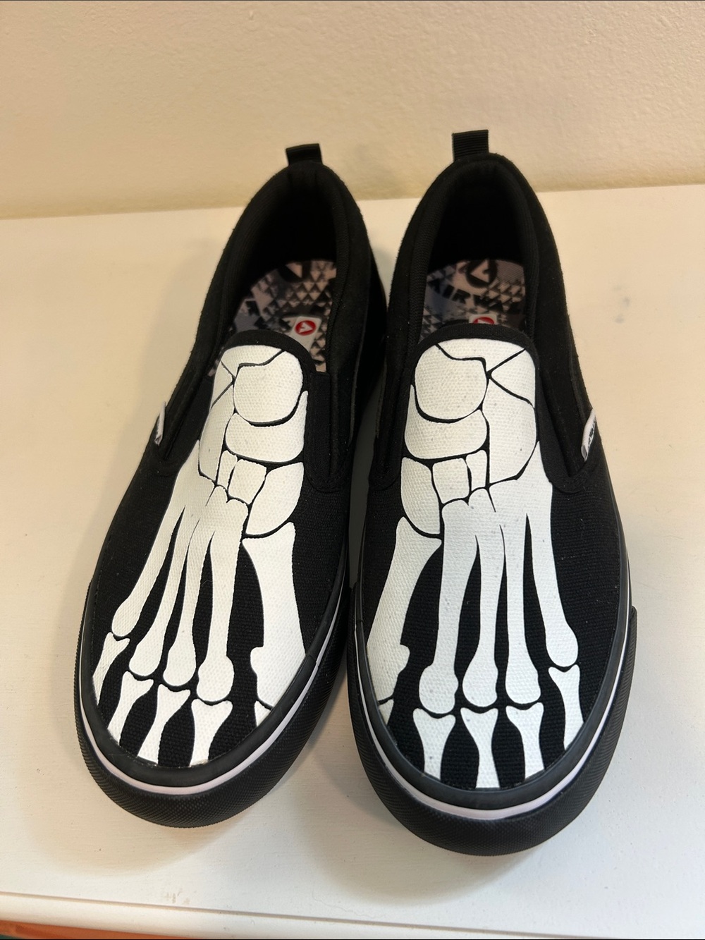 Airwalk Black Slip-On Sneakers with White Skeletal Foot Print
